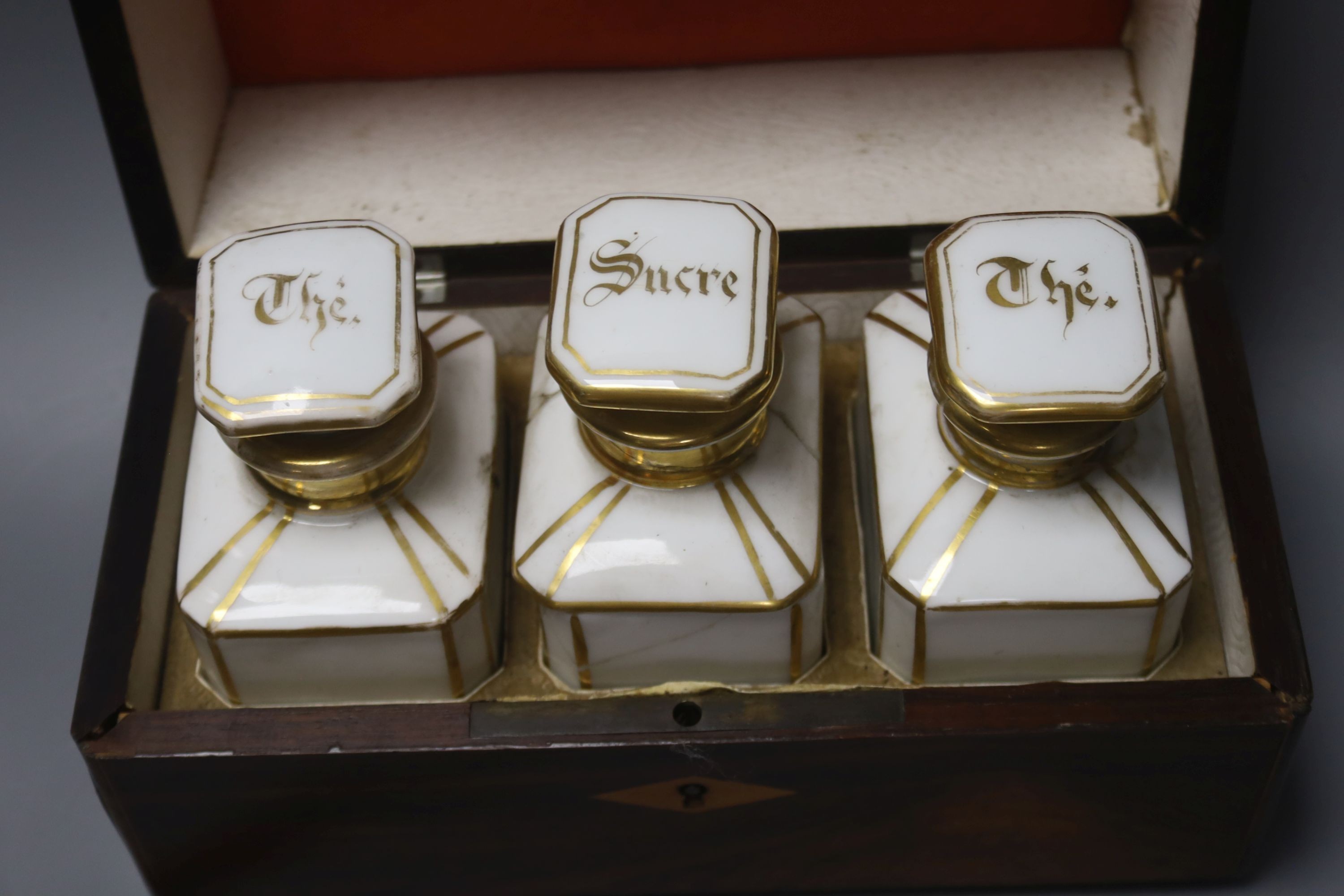 A French rosewood tea caddy, a tortoishell box, a camera and another box